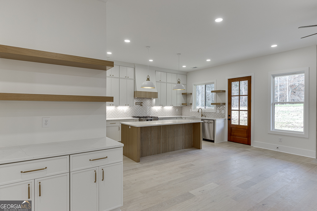 5422 Copper Crk Road Flowery Branch, GA 30542 - Photo 13 of 57 a kitchen with granite countertop a sink and cabinets