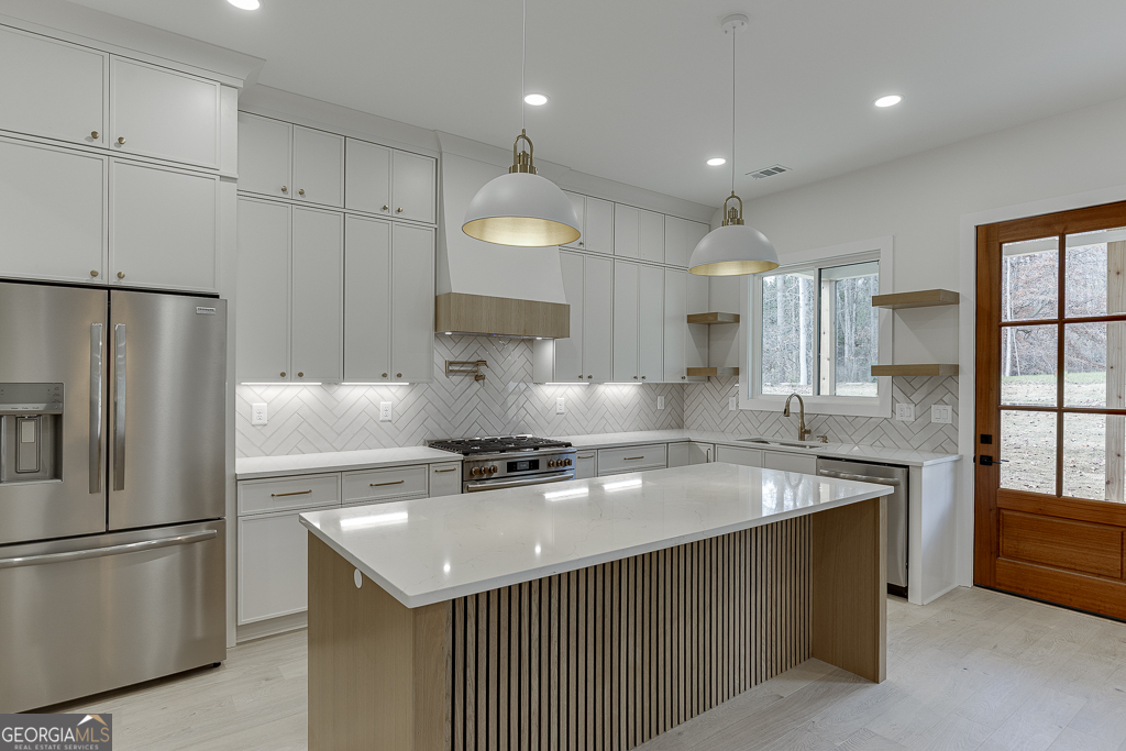 5422 Copper Crk Road Flowery Branch, GA 30542 - Photo 16 of 57 a kitchen with a sink a stove a refrigerator and cabinets