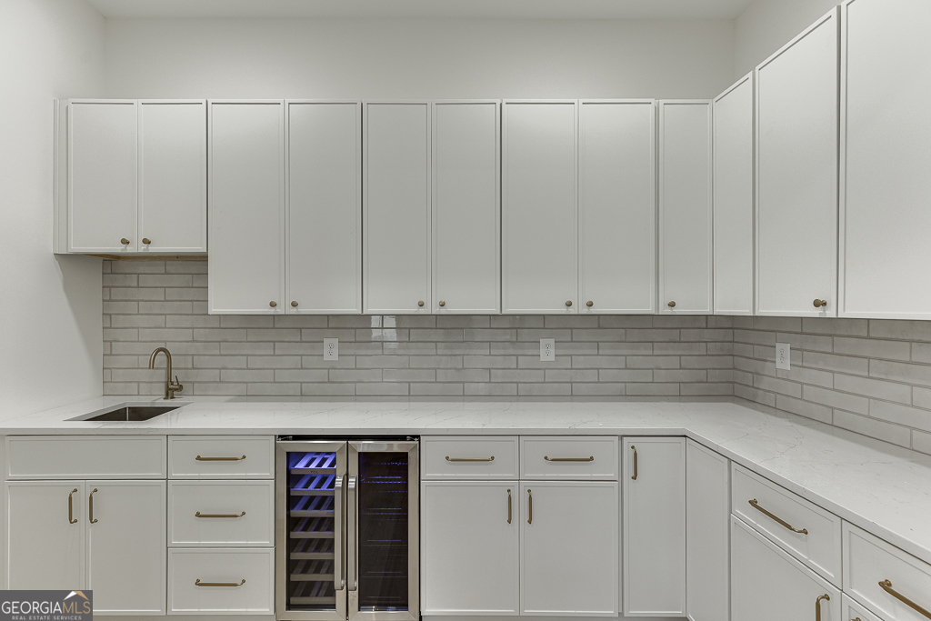 5422 Copper Crk Road Flowery Branch, GA 30542 - Photo 19 of 57 a kitchen with granite countertop white cabinets and sink