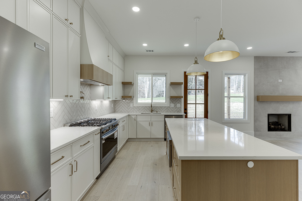 5422 Copper Crk Road Flowery Branch, GA 30542 - Photo 21 of 57 a large kitchen with stainless steel appliances granite countertop a sink a stove and a refrigerator