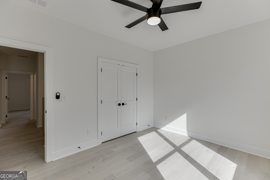 5422 Copper Crk Road Flowery Branch, GA 30542 - Photo 28 of 57 a view of a room with wooden floor and white walls