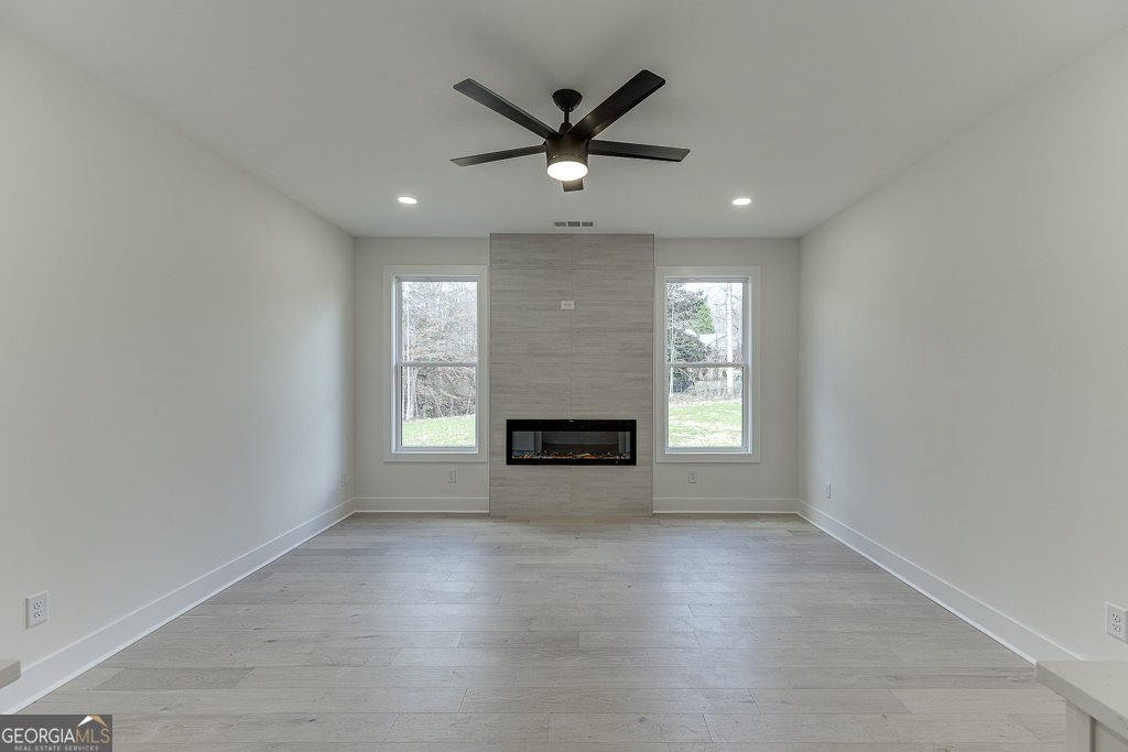 5422 Copper Crk Road Flowery Branch, GA 30542 - Photo 35 of 57 a view of a livingroom with a ceiling fan and window
