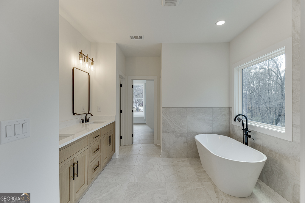 5422 Copper Crk Road Flowery Branch, GA 30542 - Photo 42 of 57 a bathroom with a double vanity sink mirror and toilet