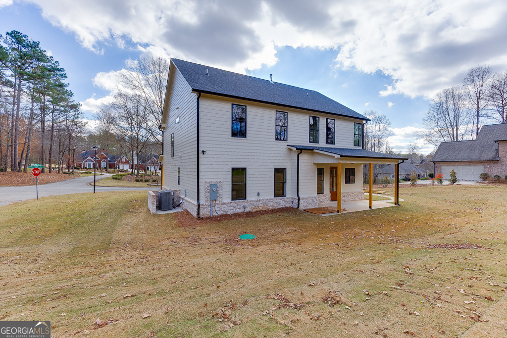 5422 Copper Crk Road Flowery Branch, GA 30542 - Photo 48 of 57 a view of a house with a big yard and large trees