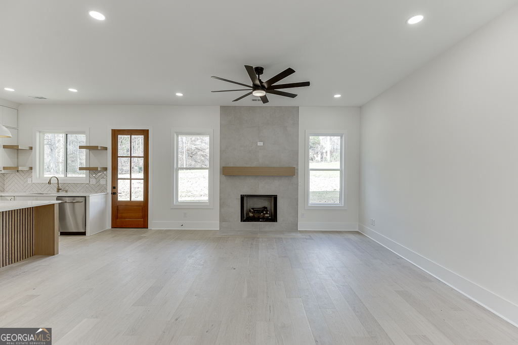 5422 Copper Crk Road Flowery Branch, GA 30542 - Photo 9 of 57 a view of a kitchen with a sink and a fireplace