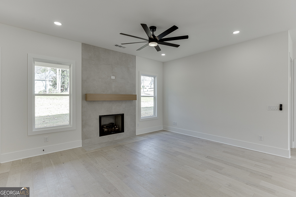 5422 Copper Crk Road Flowery Branch, GA 30542 - Photo 10 of 57 an empty room with windows and fireplace