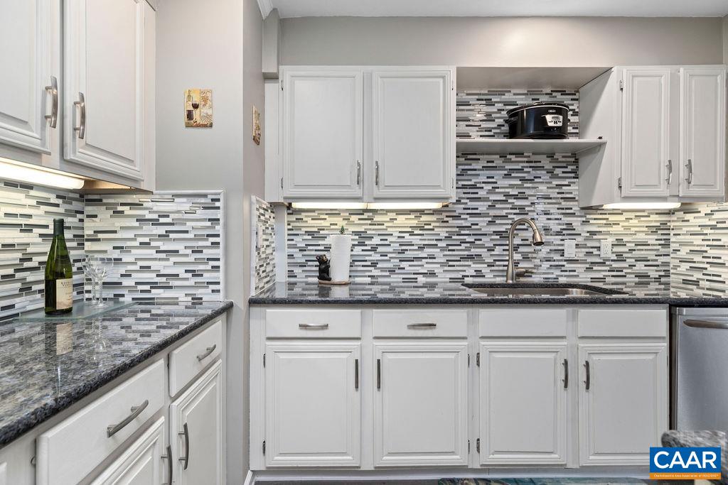 2070 Stone Ridge Wintergreen, VA 22967 - Photo 11 of 52 a kitchen with granite countertop white cabinets and white appliances