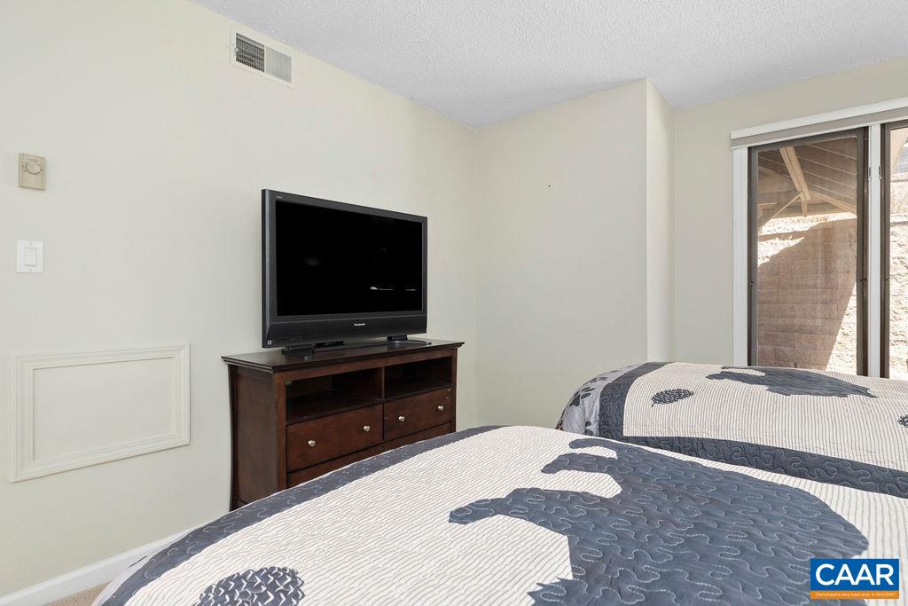 2070 Stone Ridge Wintergreen, VA 22967 - Photo 27 of 52 a bedroom with a bed and a flat screen tv