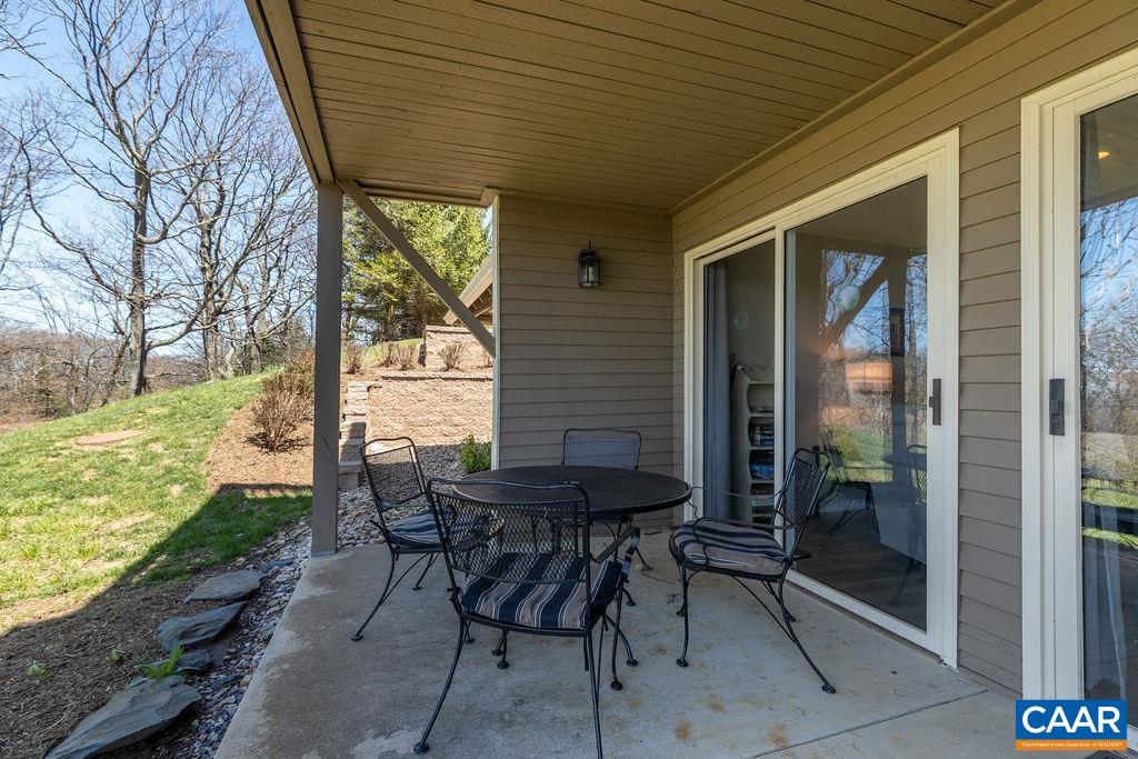 2070 Stone Ridge Wintergreen, VA 22967 - Photo 33 of 52 a patio with table and chairs and potted plants