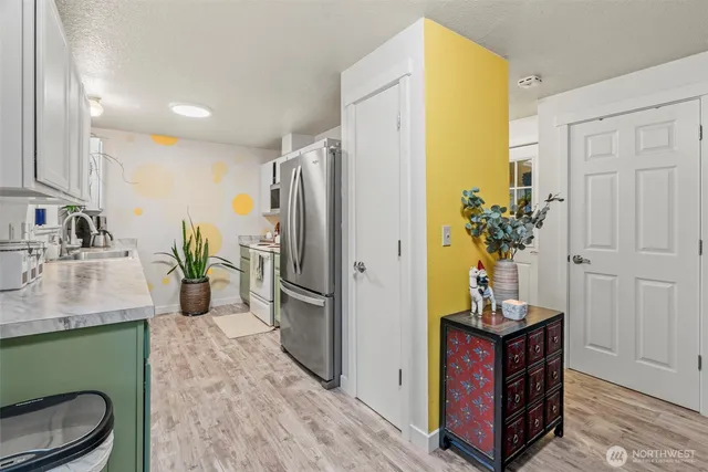 a kitchen with a refrigerator and a sink