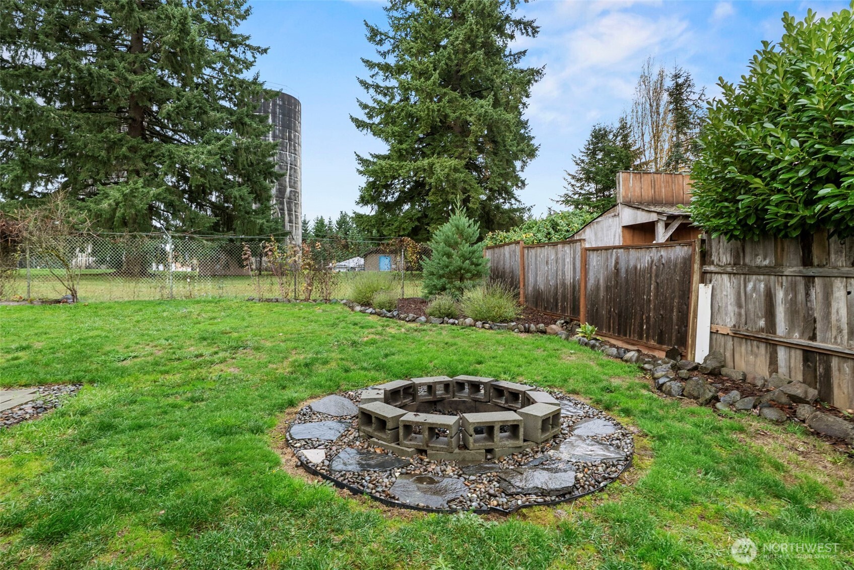 324 Cedar Court Winlock, WA 98596 - Photo 22 of 25 a view of a backyard with table and chairs plants and large tree