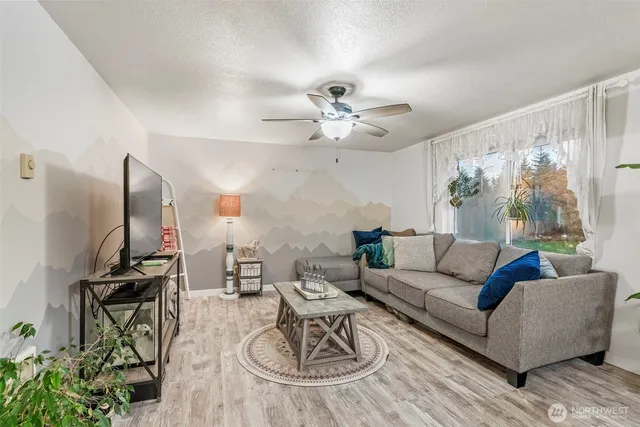a living room with furniture a rug and a chandelier