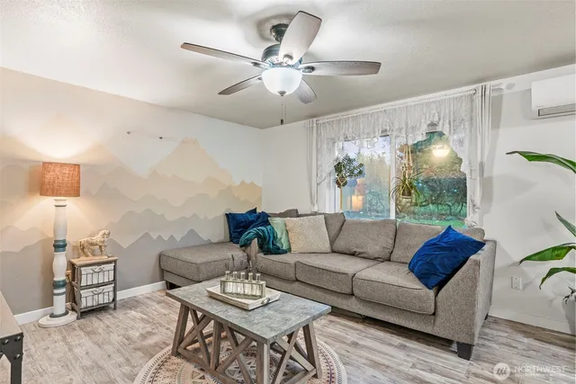 a living room with furniture and a chandelier