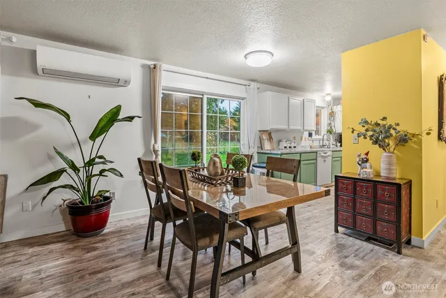 a dining room with furniture potted plants and wooden floor
