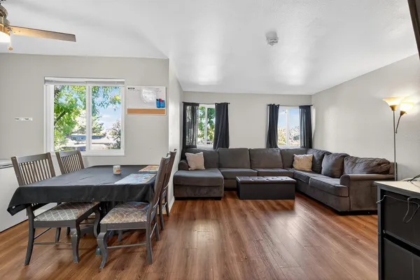 a living room with furniture and a wooden floor