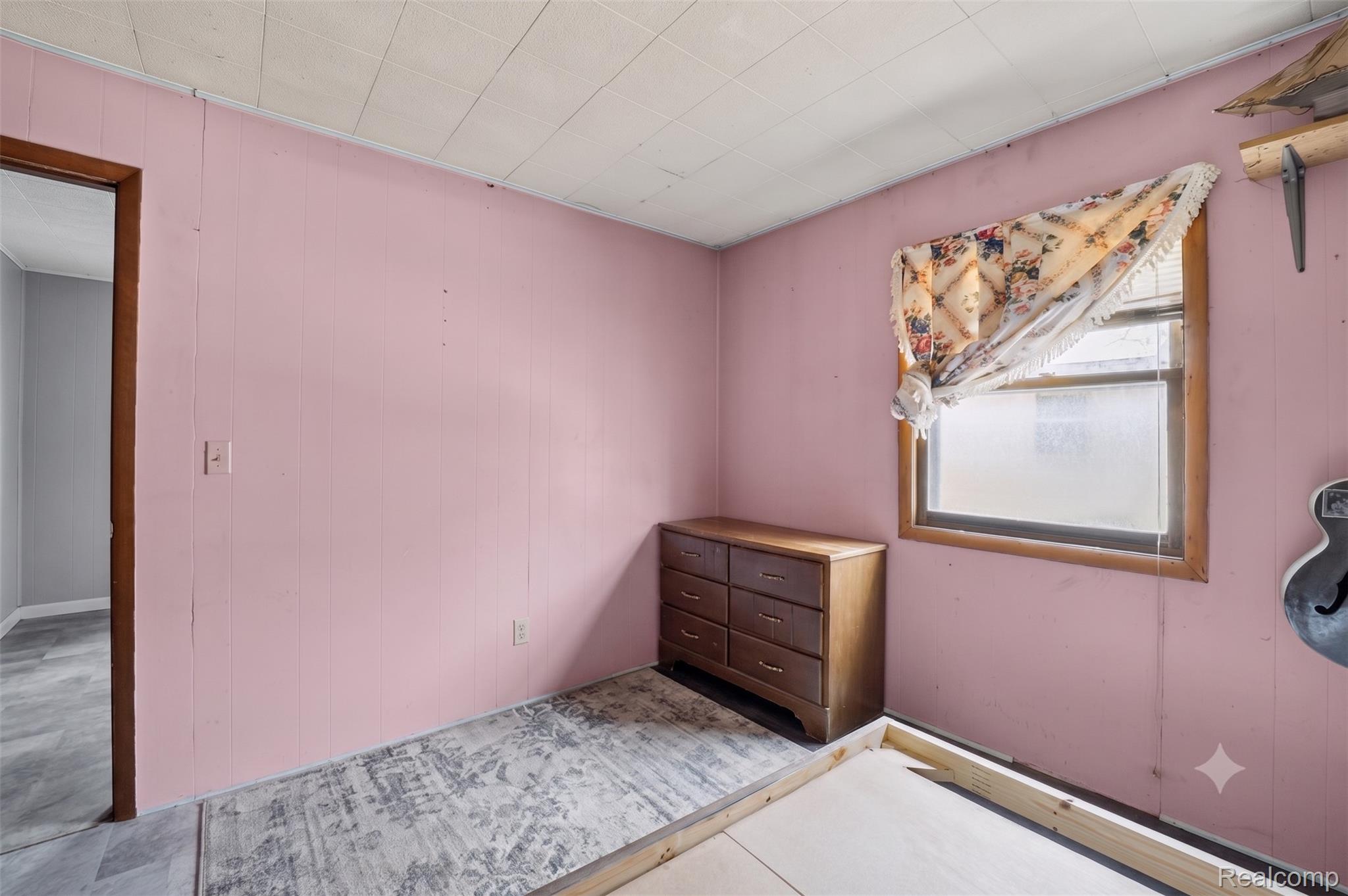 2166 South Forman Road Baldwin, MI 49304 - Photo 18 of 31 Room featuring wood-finish flooring and a single window with wood trim