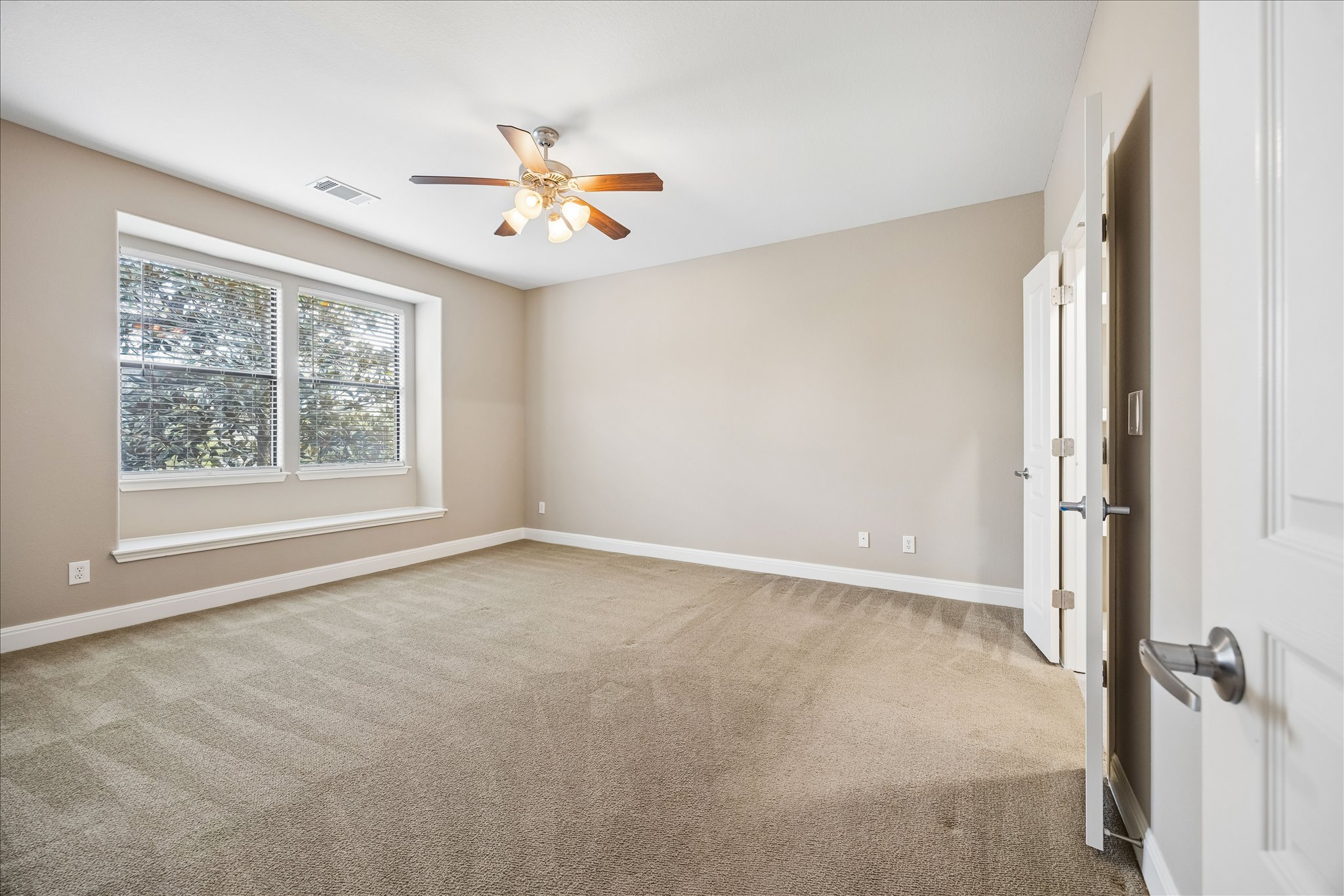 6705 Covered Bridge Drive, Unit 24 Austin, TX 78736 - Photo 13 of 31 an empty room with windows and fan