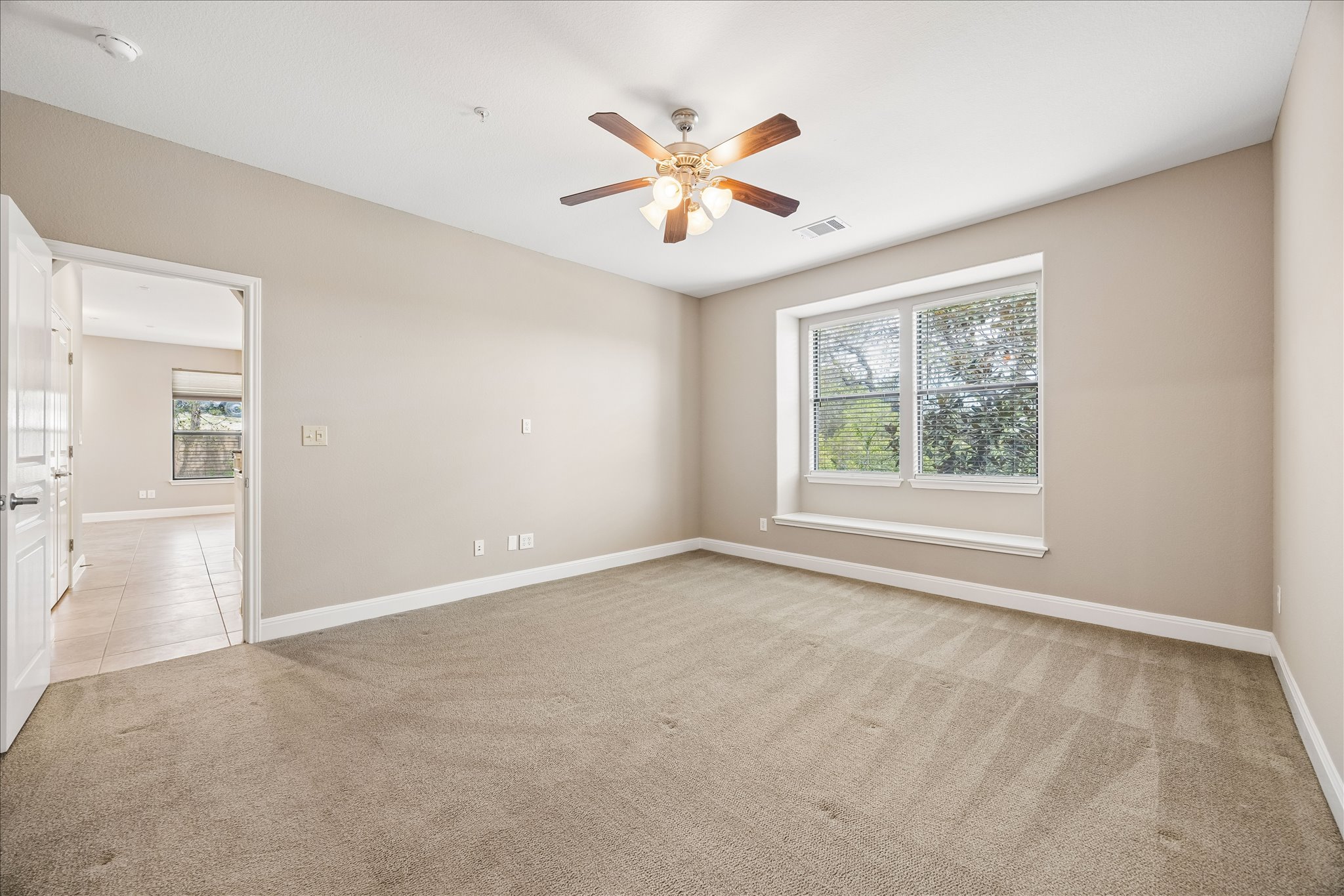6705 Covered Bridge Drive, Unit 24 Austin, TX 78736 - Photo 14 of 31 an empty room with fan and windows