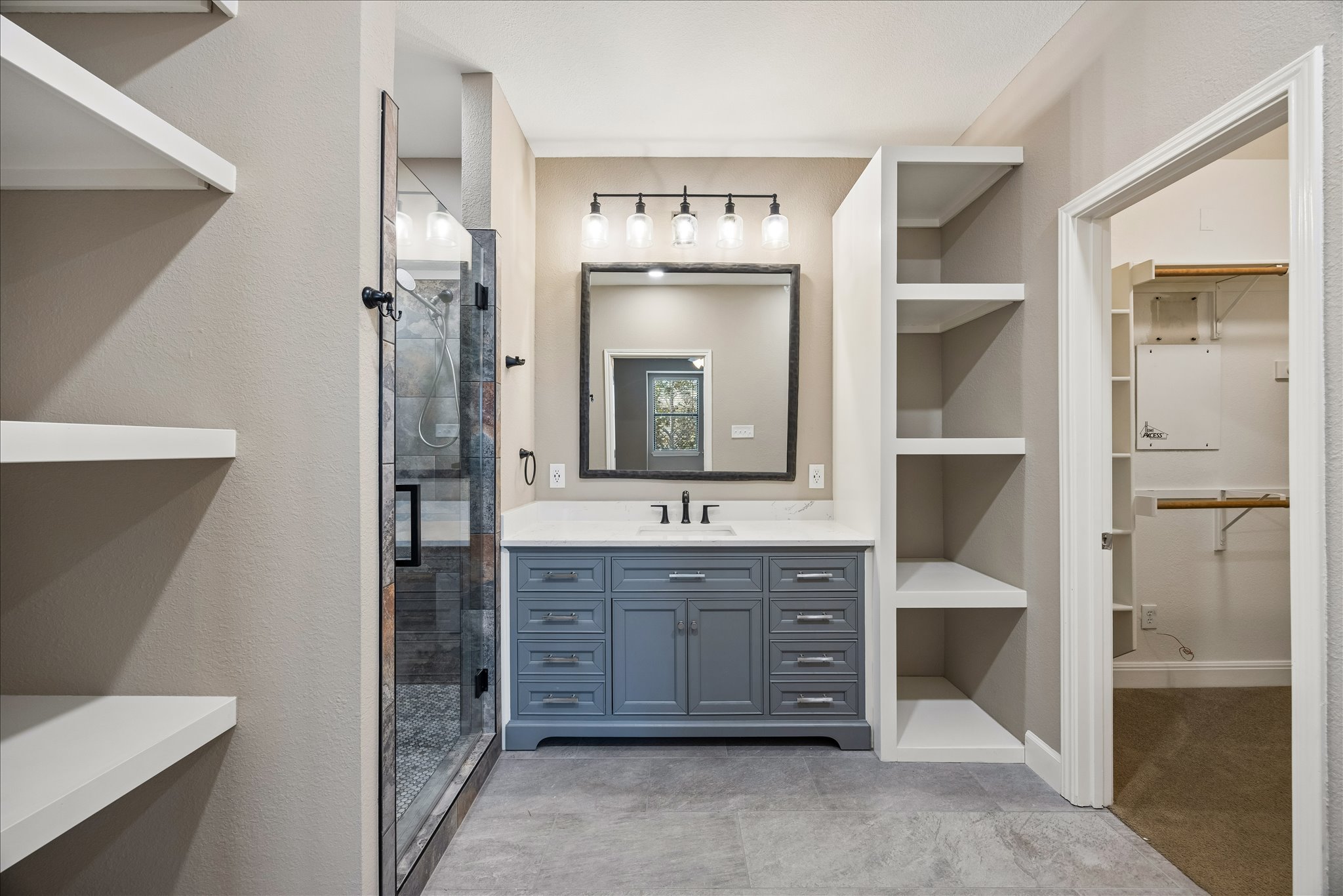 6705 Covered Bridge Drive, Unit 24 Austin, TX 78736 - Photo 17 of 31 a spacious bathroom with a granite countertop sink and a mirror