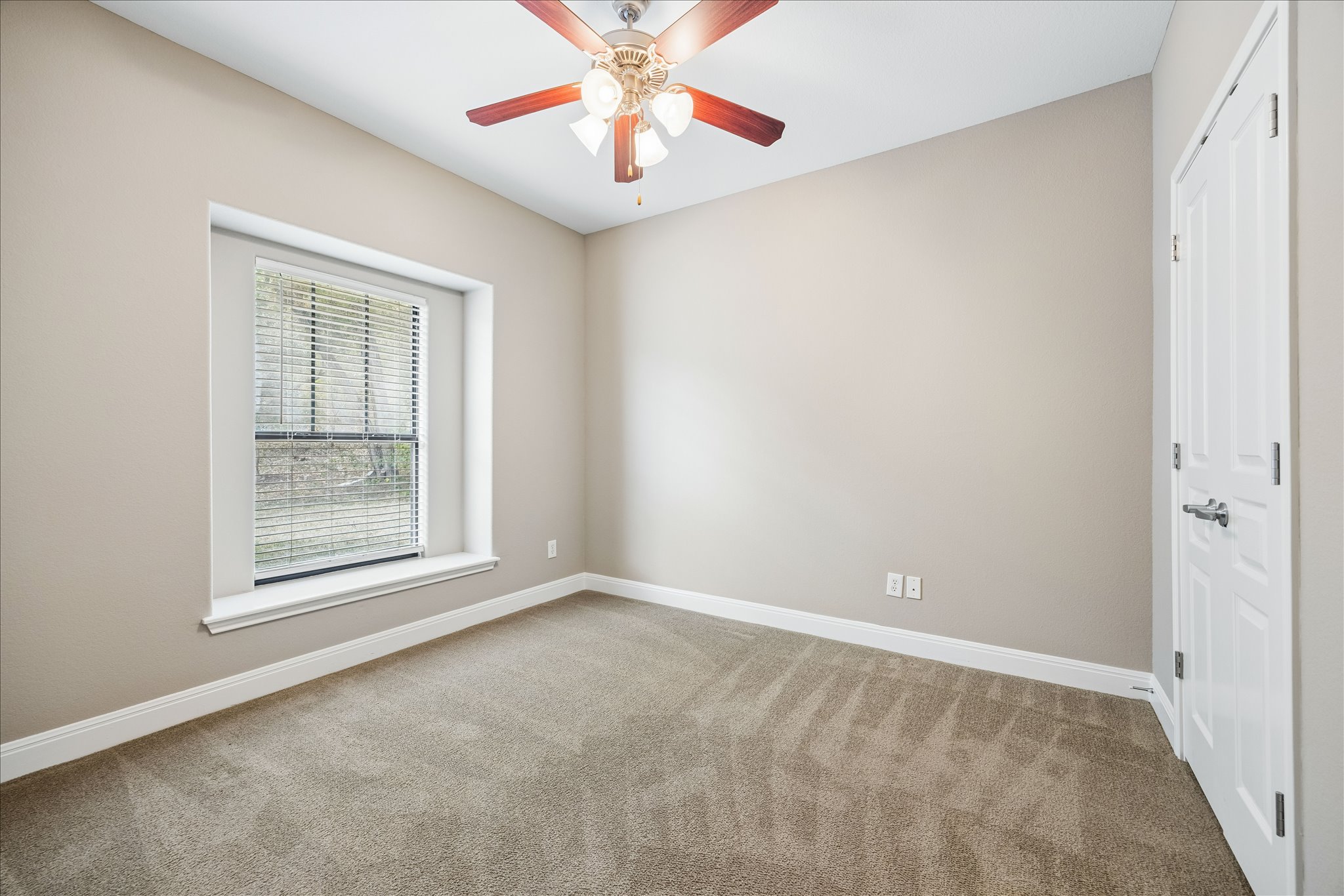 6705 Covered Bridge Drive, Unit 24 Austin, TX 78736 - Photo 23 of 31 an empty room with chandelier fan and window
