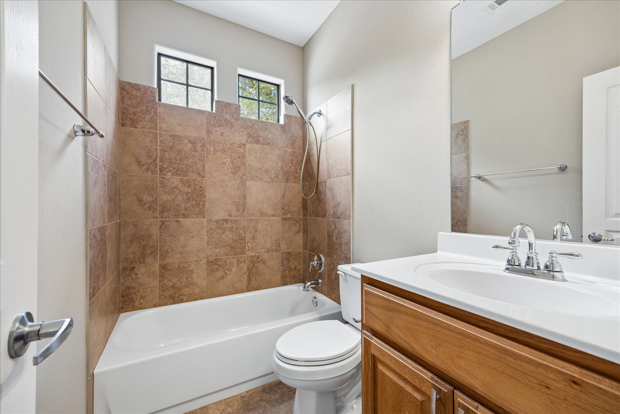 6705 Covered Bridge Drive, Unit 24 Austin, TX 78736 - Photo 25 of 31 a bathroom with a sink a toilet and shower