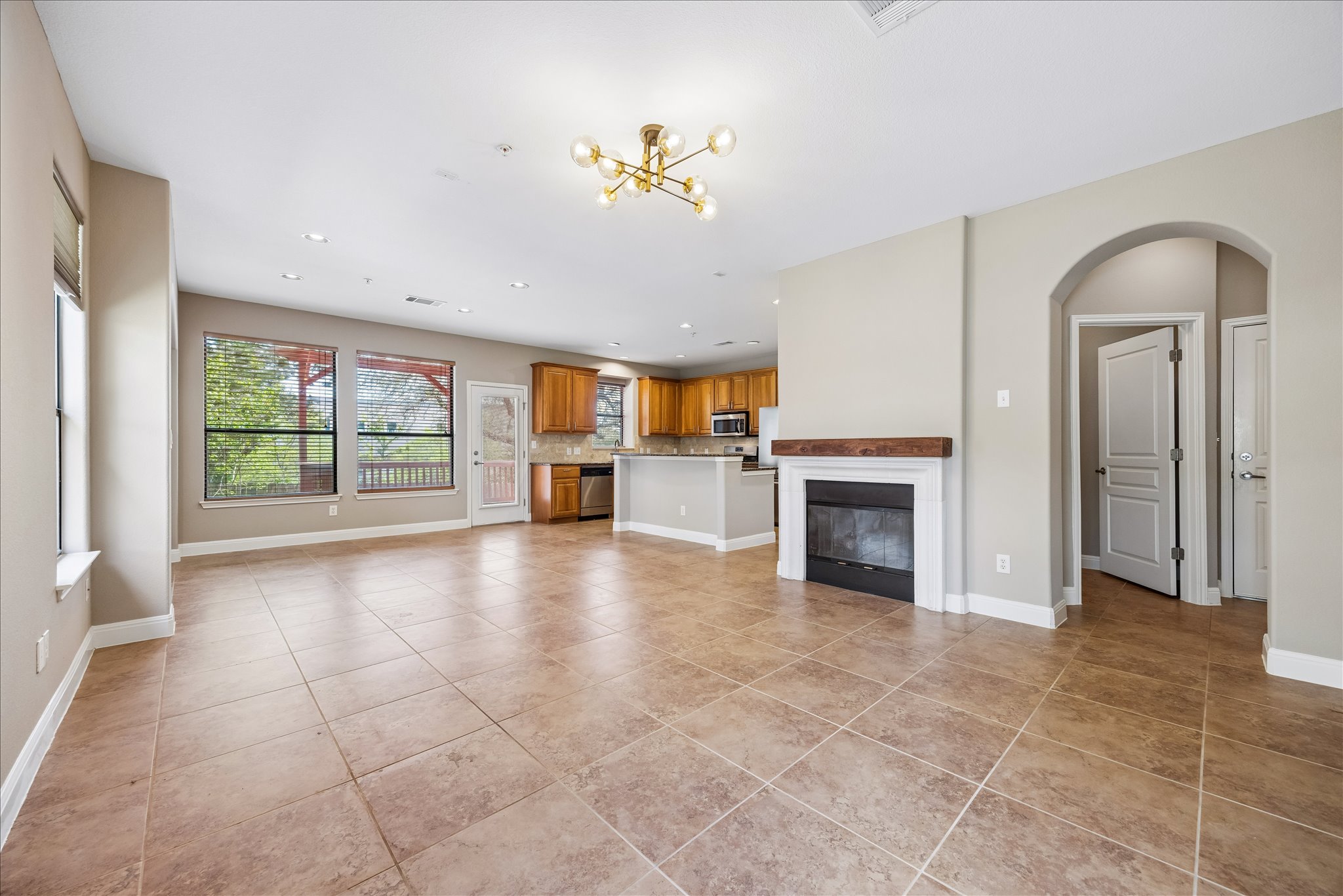 6705 Covered Bridge Drive, Unit 24 Austin, TX 78736 - Photo 4 of 31 a view of a livingroom with a fireplace cabinet and windows