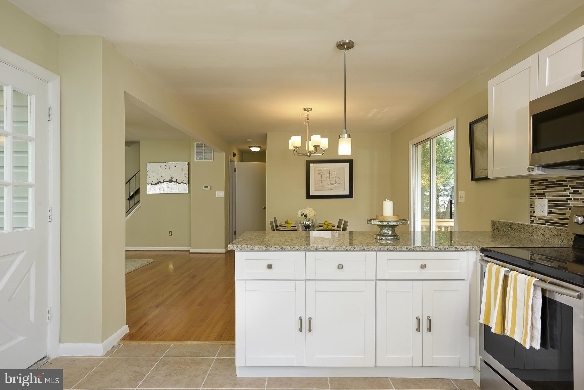 8413 Garland Road Pasadena, MD 21122 - Photo 12 of 30 a bathroom with a sink a vanity a mirror and shower