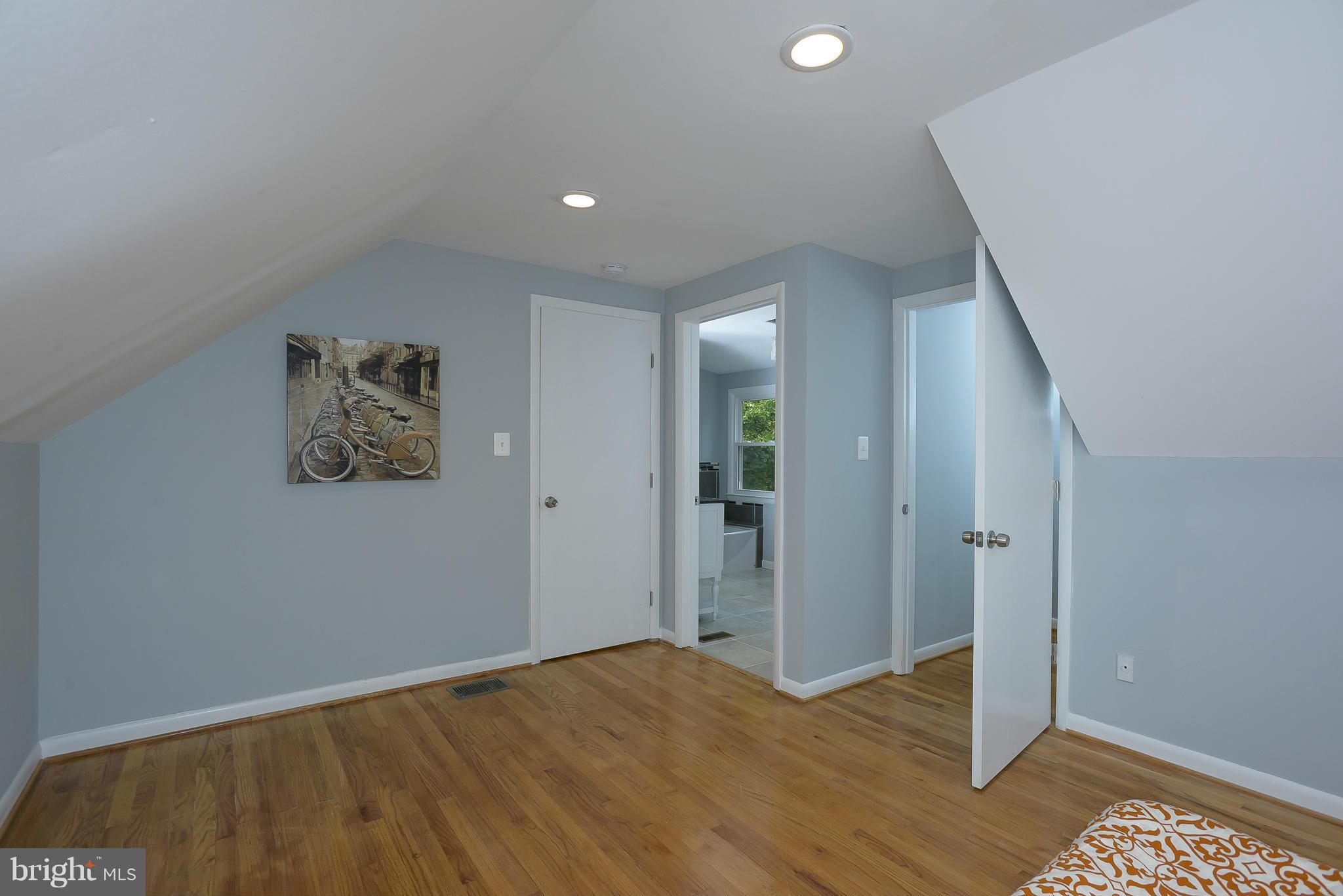 8413 Garland Road Pasadena, MD 21122 - Photo 14 of 30 an empty room with wooden floor and bathroom