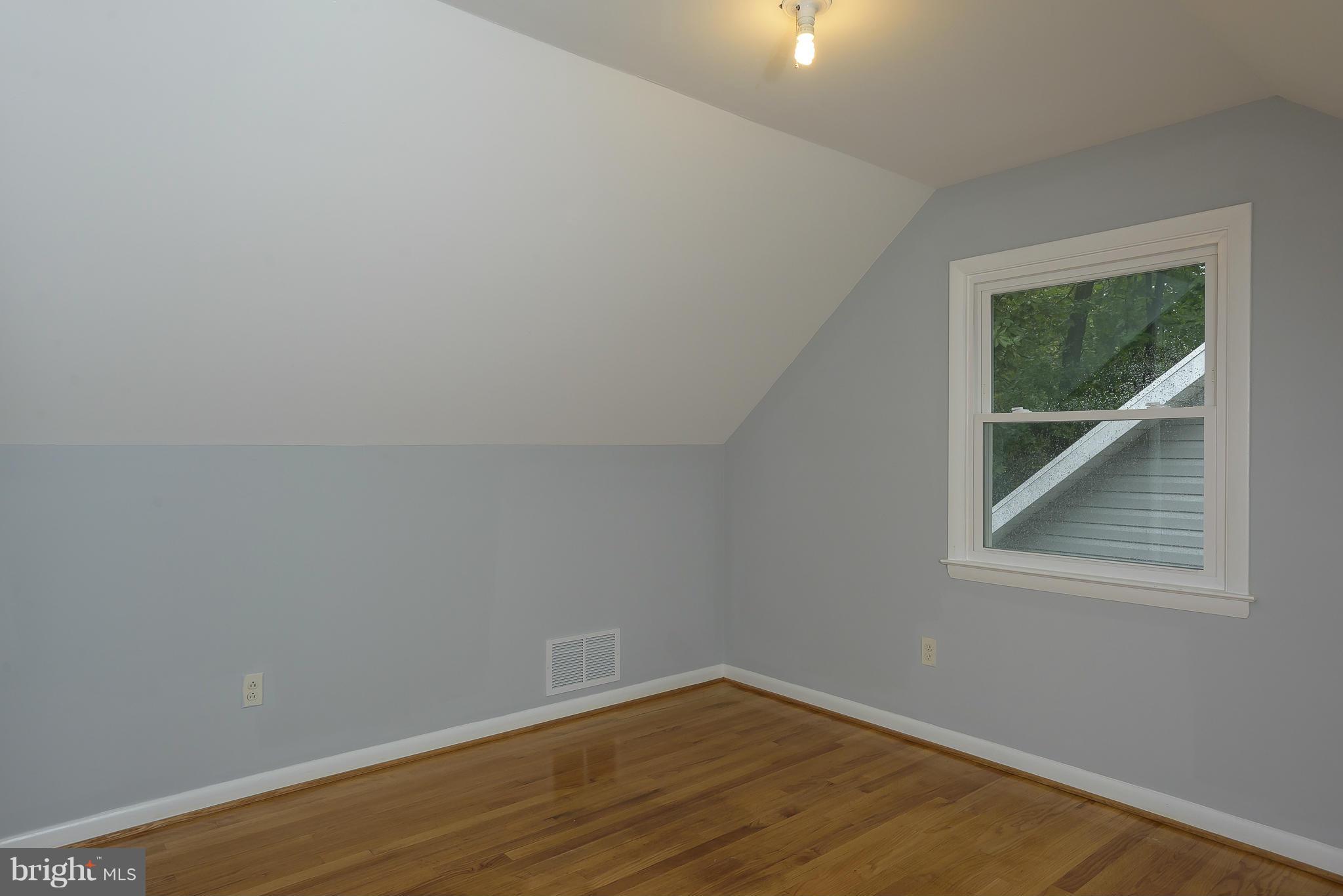 8413 Garland Road Pasadena, MD 21122 - Photo 17 of 30 a view of an empty room with wooden floor and a window