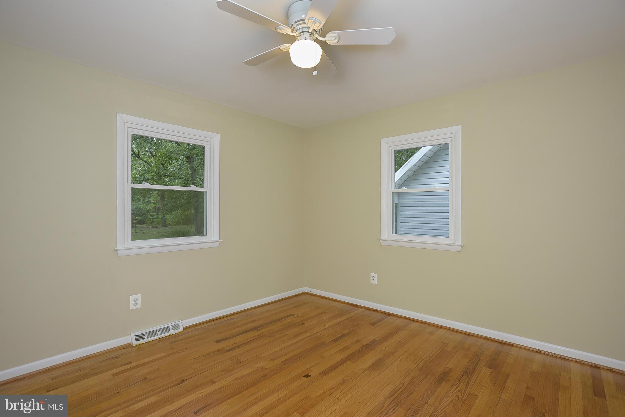 8413 Garland Road Pasadena, MD 21122 - Photo 20 of 30 a view of an empty room with wooden floor and a window