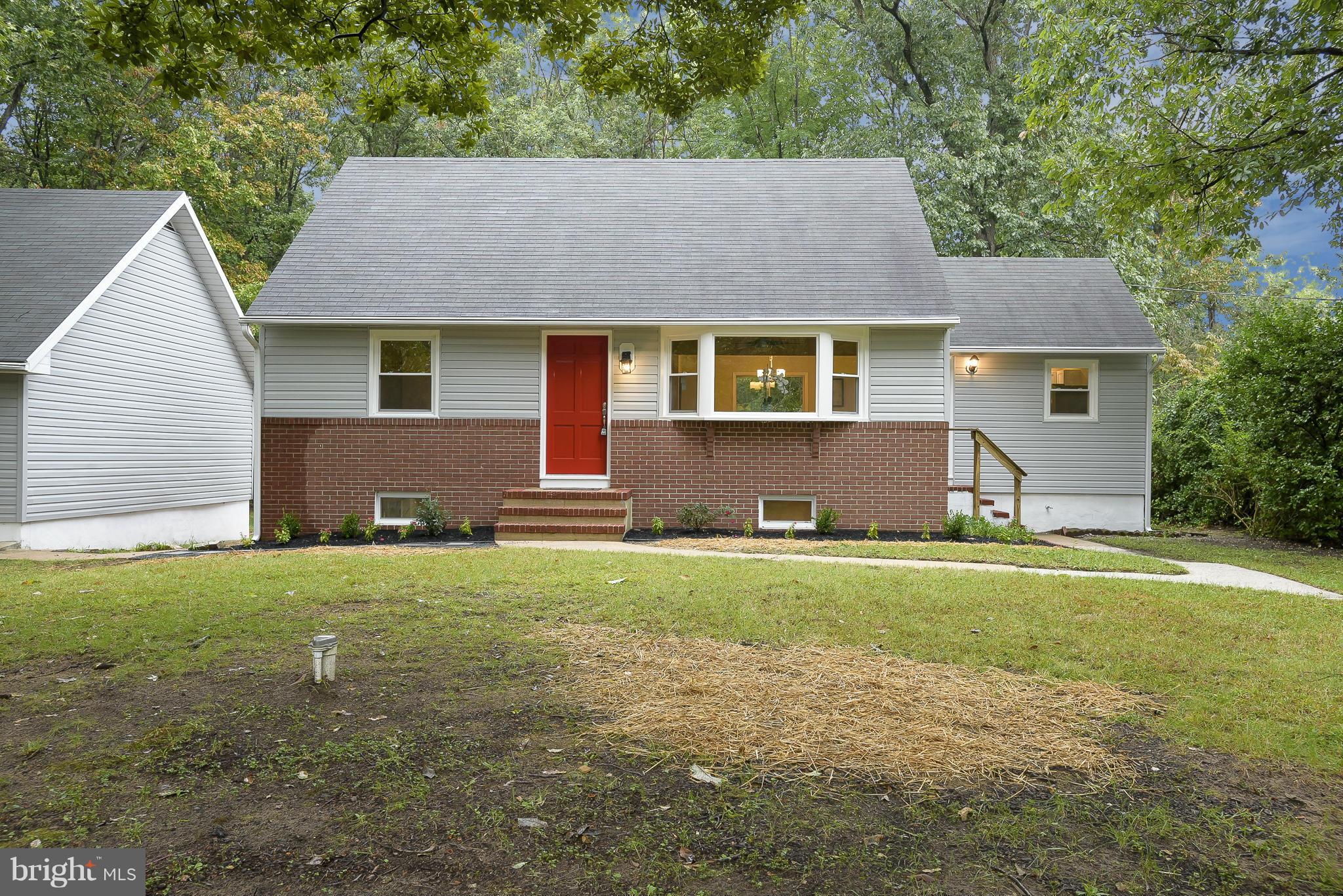 8413 Garland Road Pasadena, MD 21122 - Photo 3 of 30 a front view of house with yard and trees
