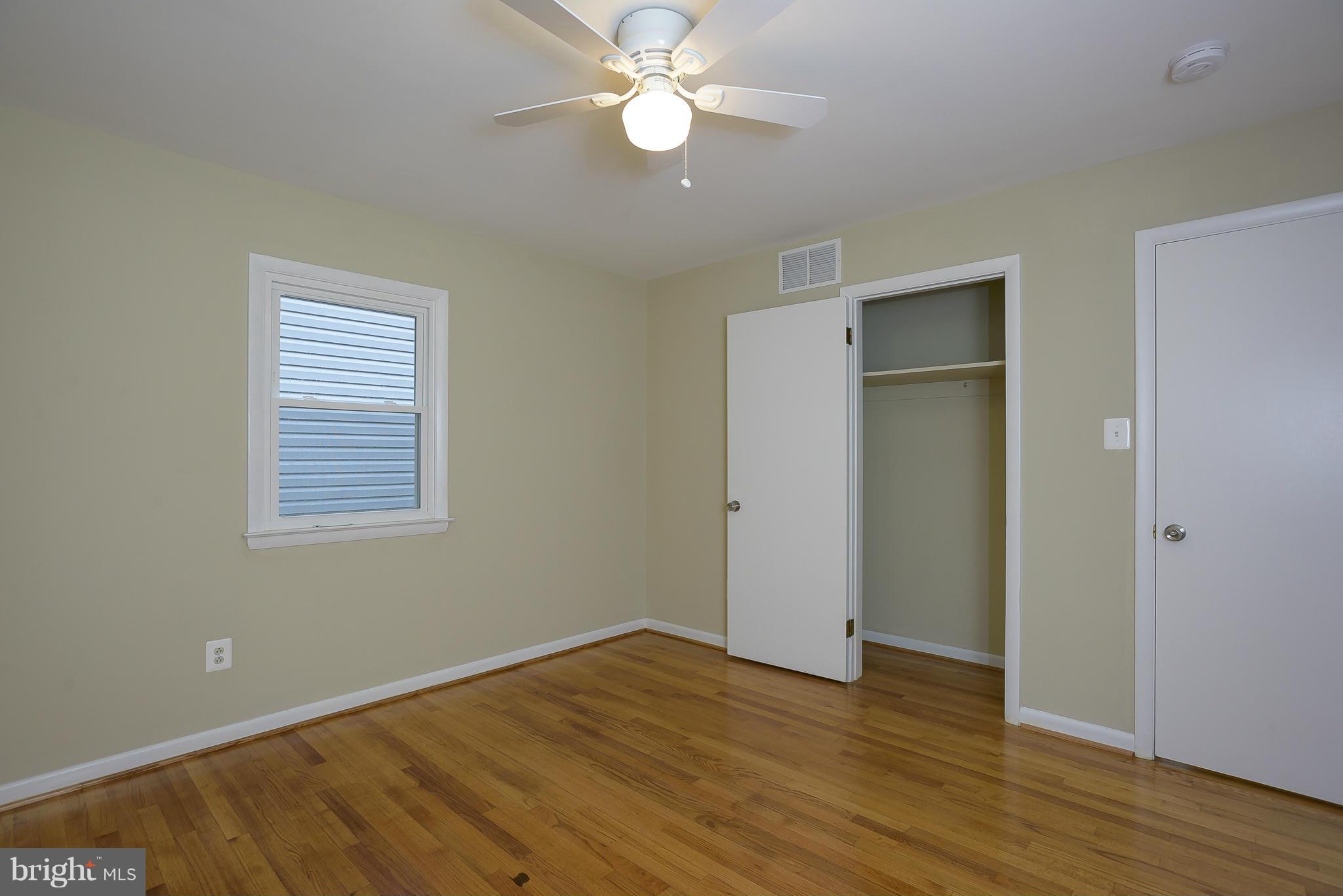 8413 Garland Road Pasadena, MD 21122 - Photo 21 of 30 a view of an empty room with wooden floor and a window