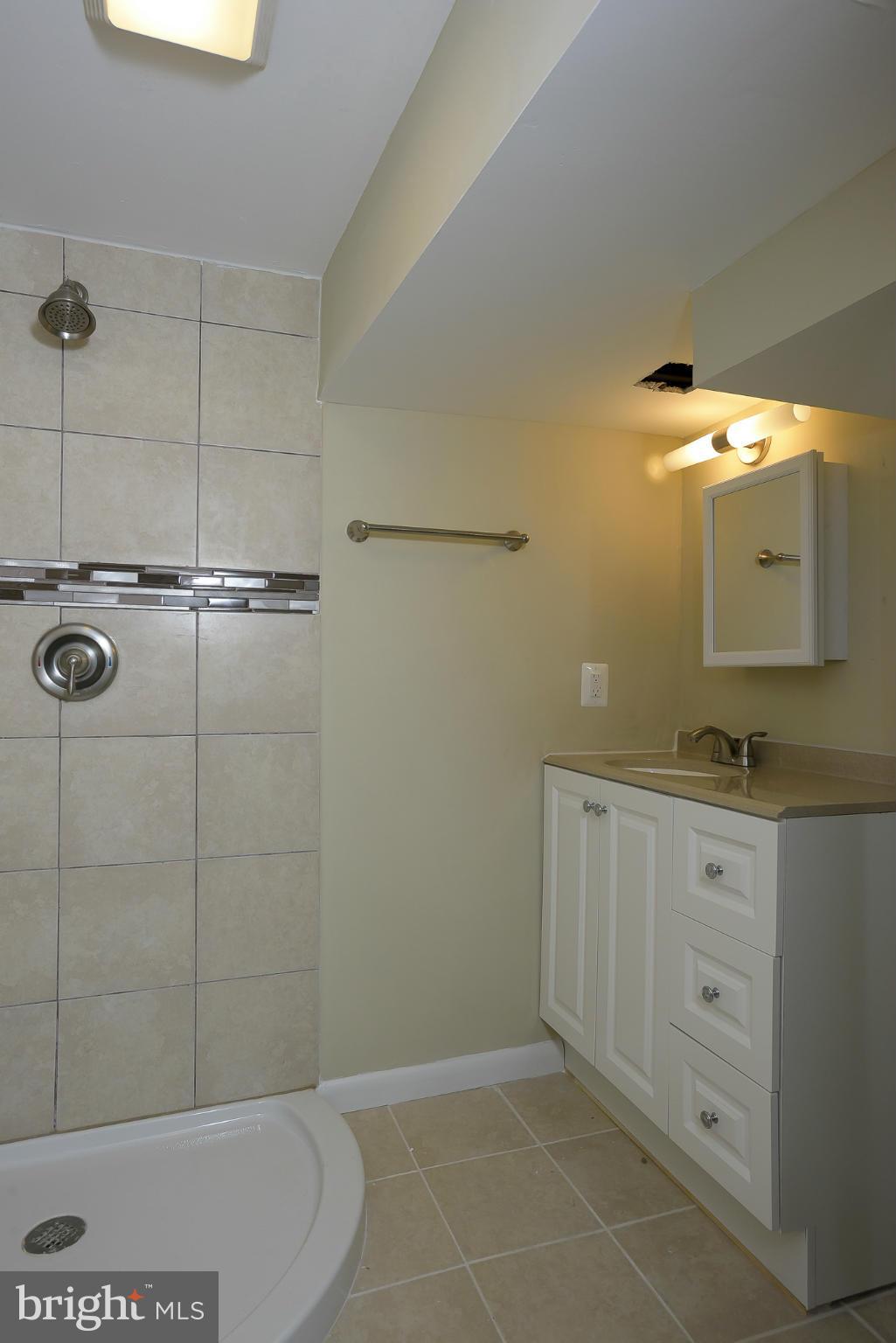 8413 Garland Road Pasadena, MD 21122 - Photo 25 of 30 a bathroom with a sink and mirror