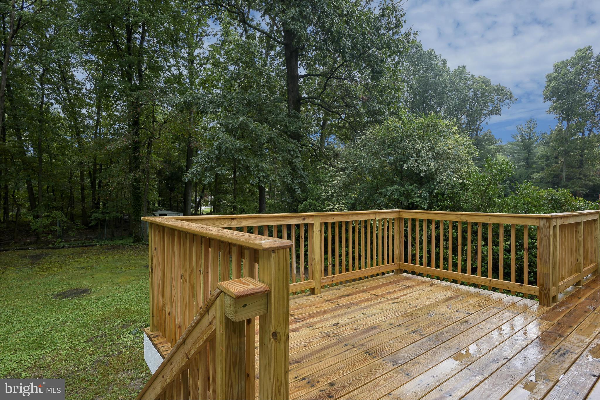 8413 Garland Road Pasadena, MD 21122 - Photo 27 of 30 a balcony with wooden floor and yard in the back
