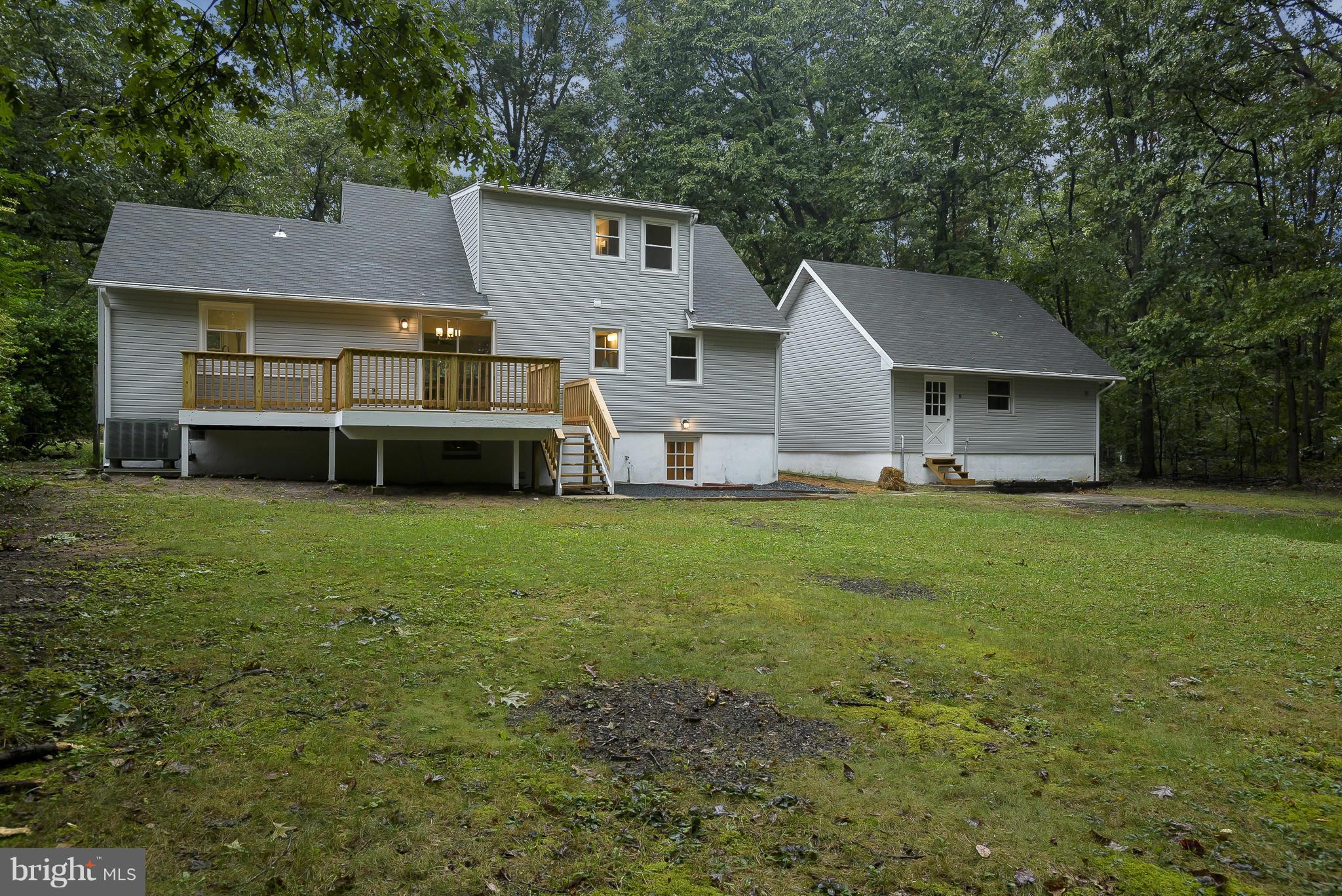 8413 Garland Road Pasadena, MD 21122 - Photo 29 of 30 a front view of a house with a garden and trees