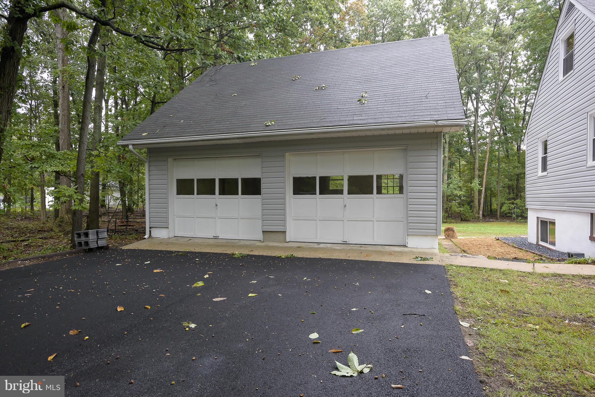 8413 Garland Road Pasadena, MD 21122 - Photo 4 of 30 a front view of a house with a yard and a garage