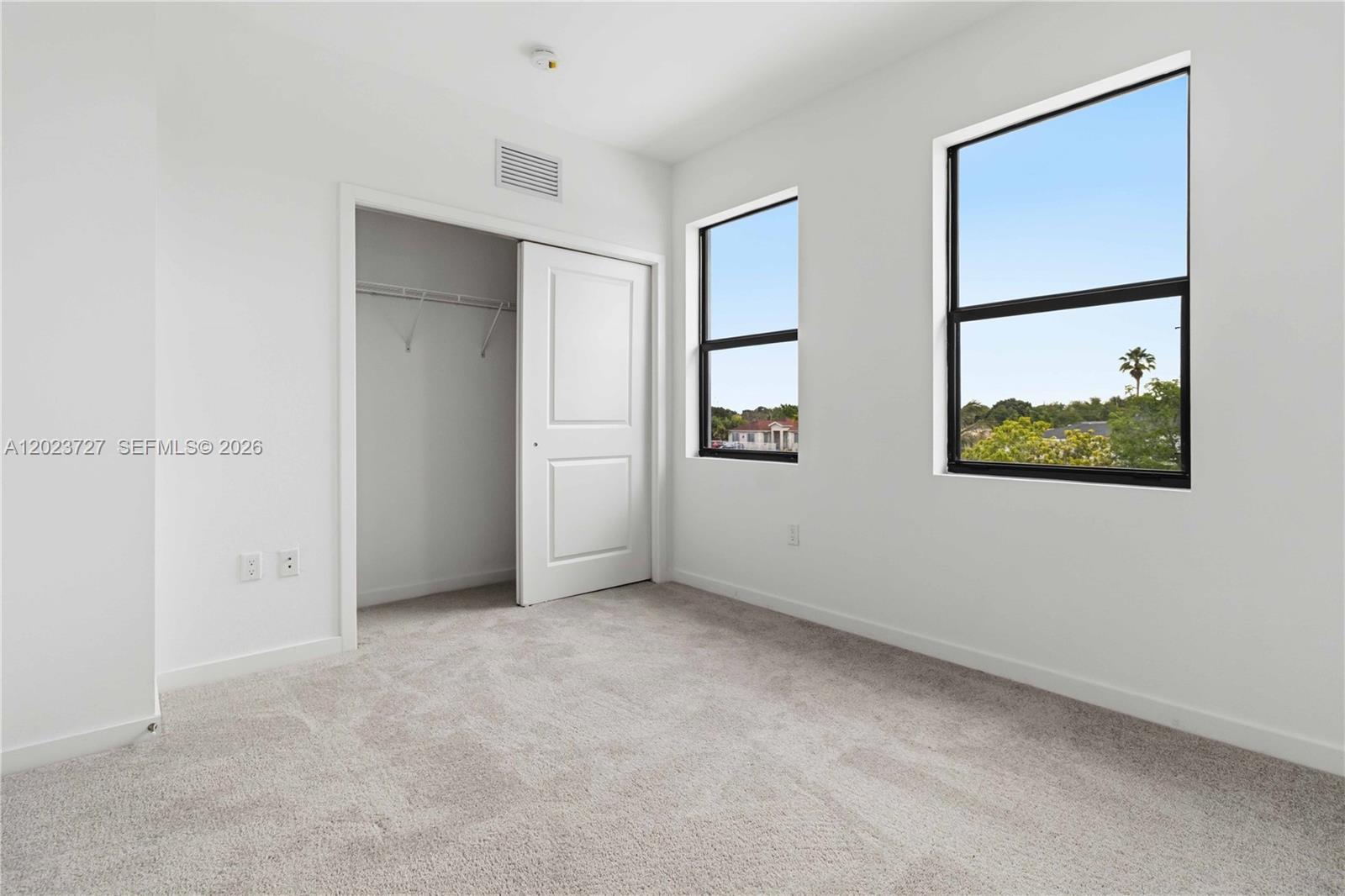 22348 Southwest 115th Court, Unit 22348 Miami, FL 33170 - Photo 12 of 37 an empty room with windows and closet