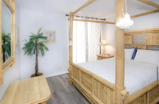 a very nice looking room with a large window a bed and a couch