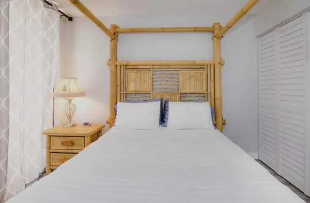 a bedroom with a bed and a night stand