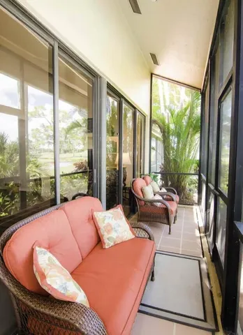 a living room with furniture and a floor to ceiling window