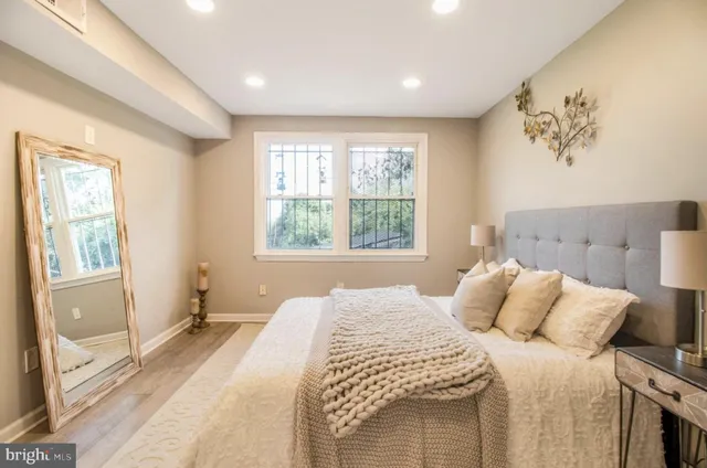 a bedroom with a large bed and a chandelier