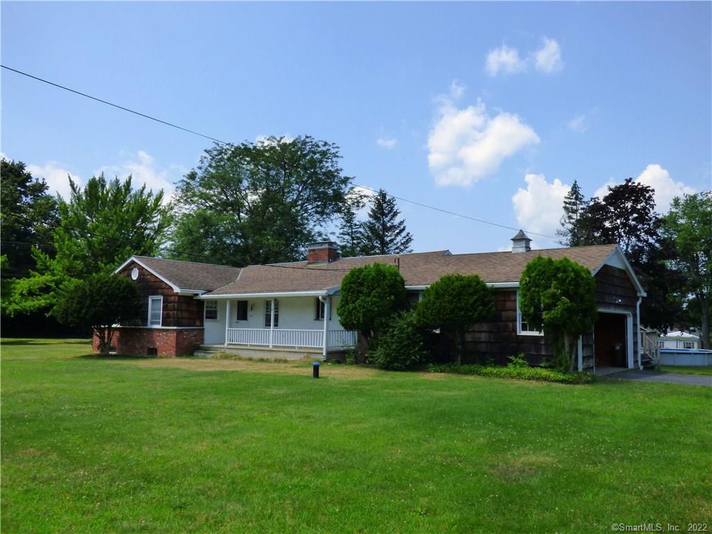 2 High Ridge Road Brookfield, CT 06804 - Photo 1 of 1 a front view of a house with a yard table and chairs