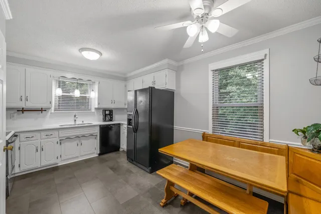 a kitchen with cabinets stainless steel appliances a sink and a window