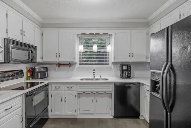 a spacious bedroom with a bed and a chandelier