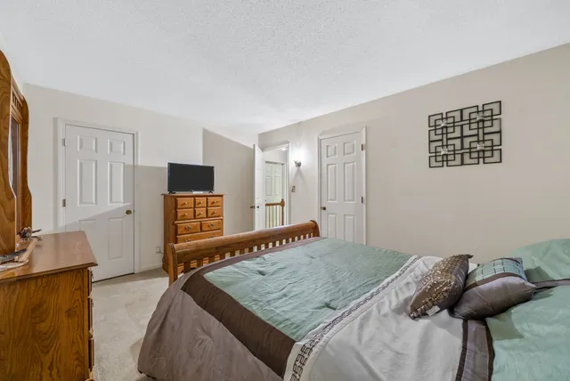 a bedroom with a bed and a desk