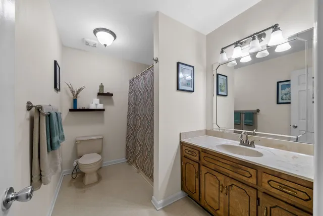 a bedroom with a bed and a white cabinet