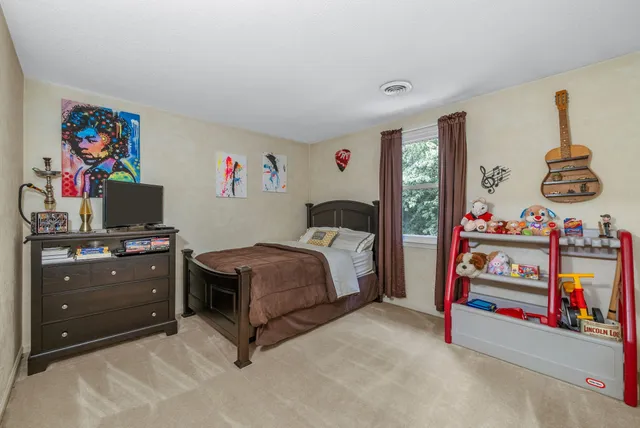a bedroom with furniture and a flat screen tv