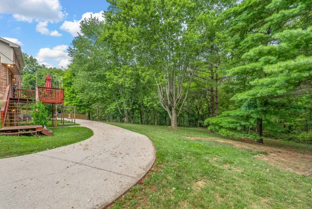 a view of a house with a yard and garage