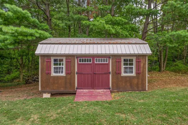 a view of a chair and table on the green field