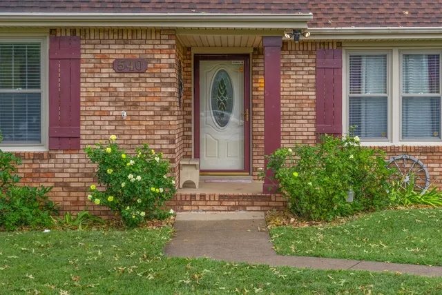 a view of a hallway with wooden floor and entryway